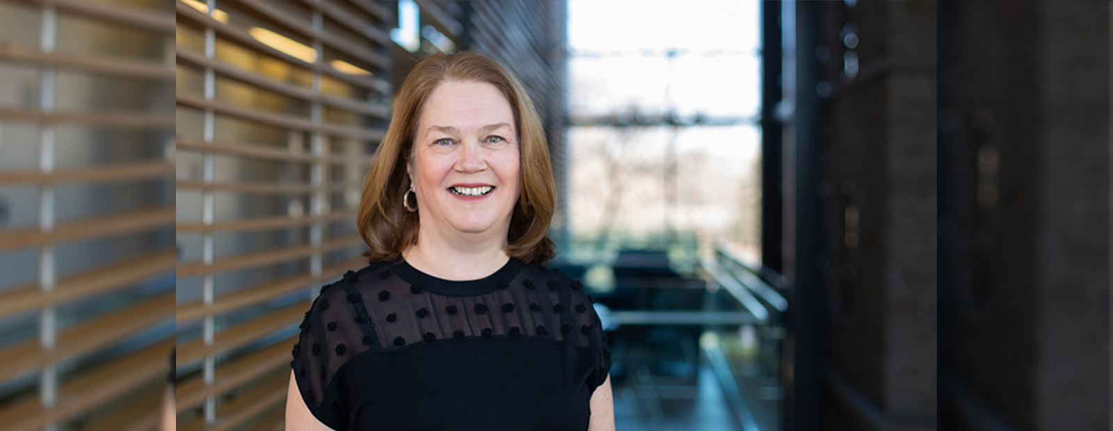 Dr. Jane Philpott wears a black shirt and smiles at the camera