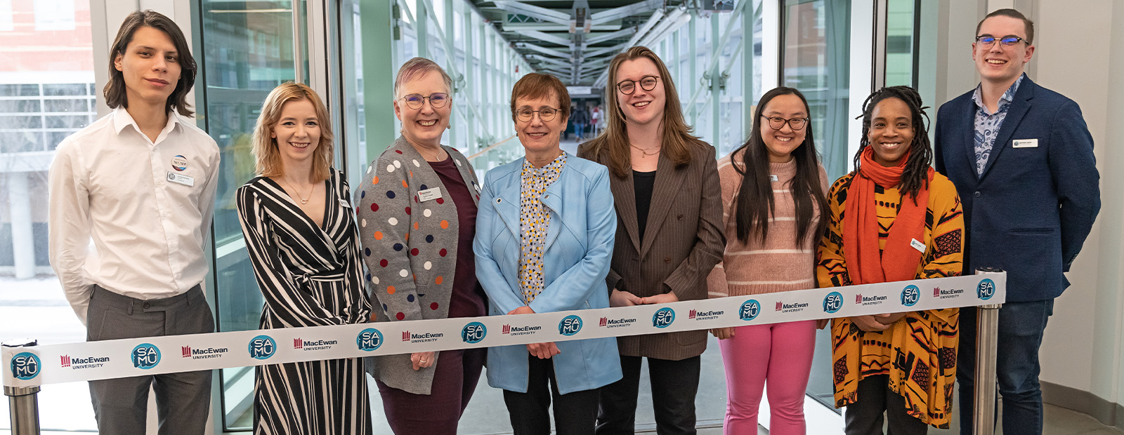 Members of SAMU student executive team and staff are joined by MacEwan Board Chair Carolyn Graham, MacEwan President and Vice-Chancellor Dr. Annette Trimbee at the entrance to the 109 Street pedway, where they prepare to cut a ribbon