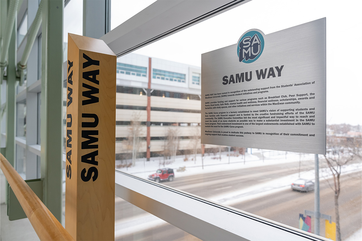 A closeup shot of the new pillar on the pedway with the name SAMU Way, and a plaque explaining why the name has been given to the location.