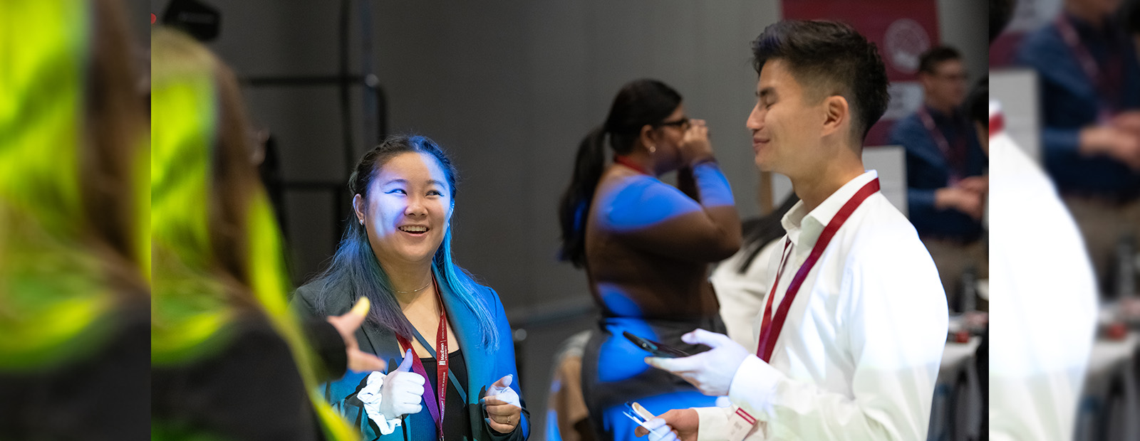 Deanna Eng smiles at a fellow student in a crowd at the Business Student Conference