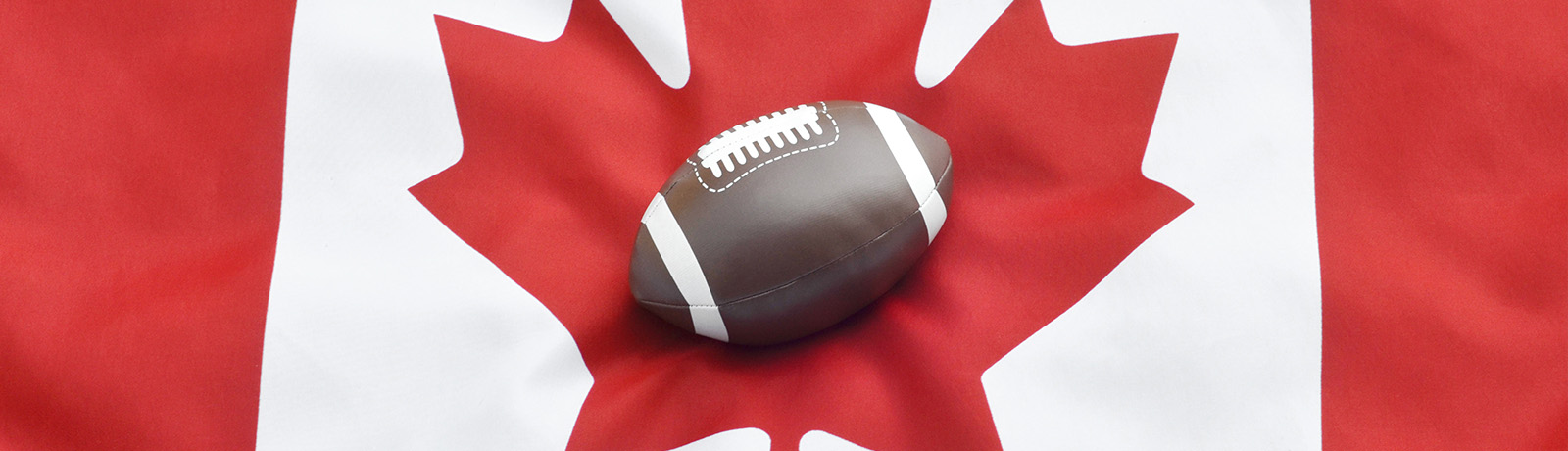 A football rests on the Canadian flag