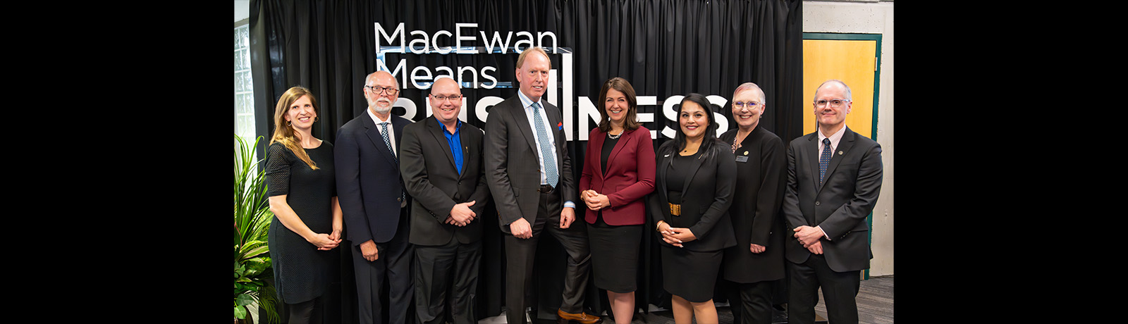 Dignitaries stand in front of a MacEwan Means Business banner at the event on November 20.