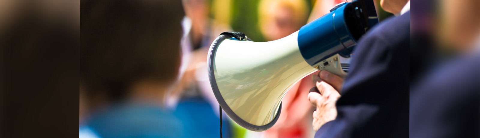 A person holds in a megaphone in a crowd