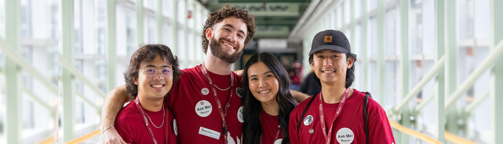 Four MacEwan volunteers stand beside one another smiling