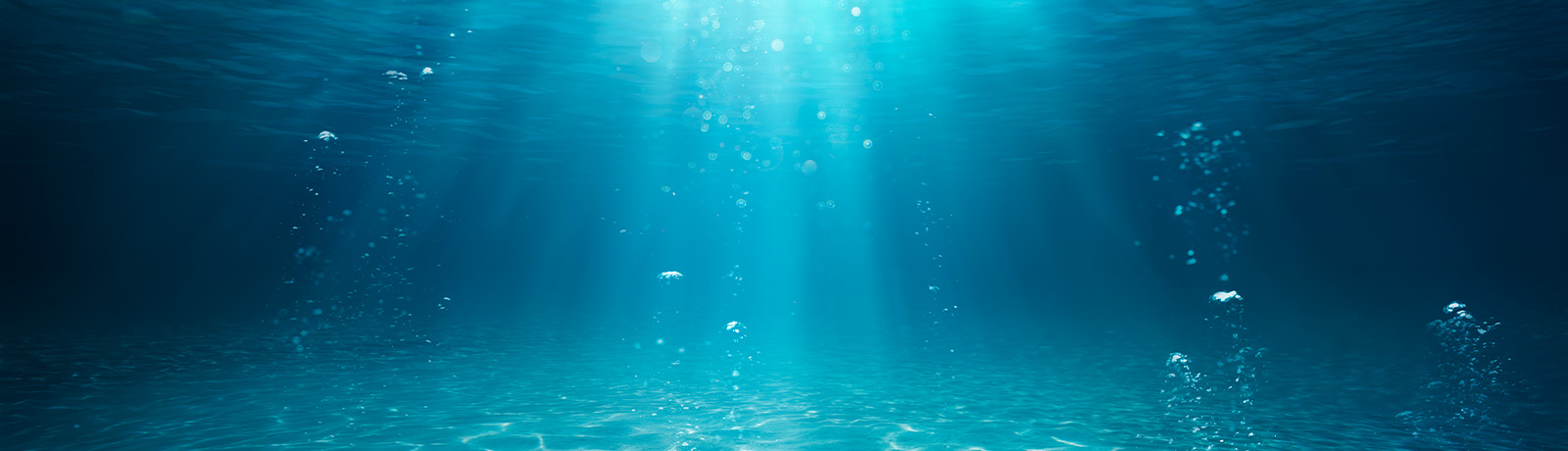 Underwater shot of clear blue water with sunlight shining through