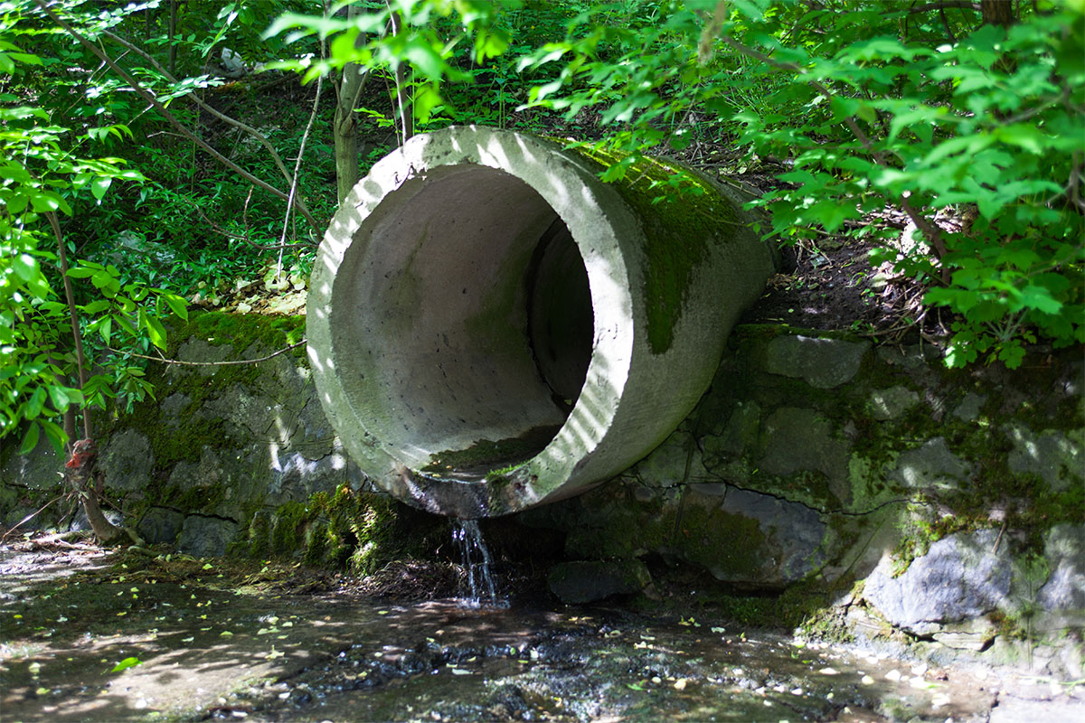 Stormwater runoff from a concrete pipe into a body of water