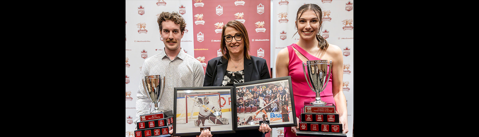 Ashton Abel and Mariah Bereziuk stand on either side of Chandelle Rimmer, who holds framed photos of the student athletes playing their respective sports.