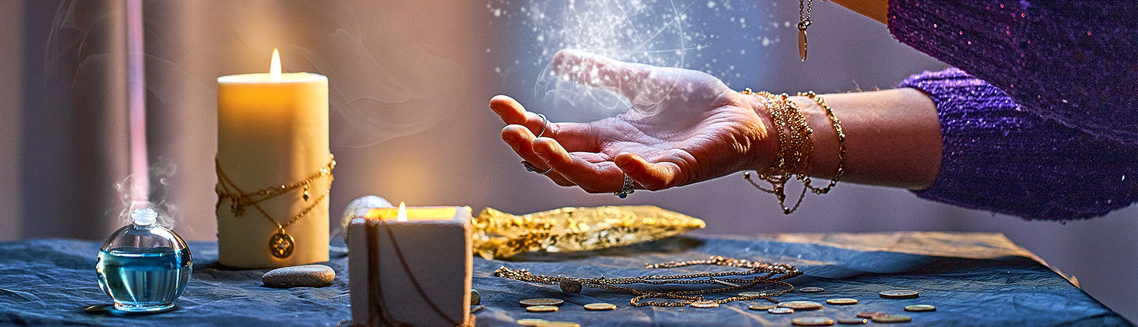 A woman's hands, adorned with rings, appear to hold onto light and energy