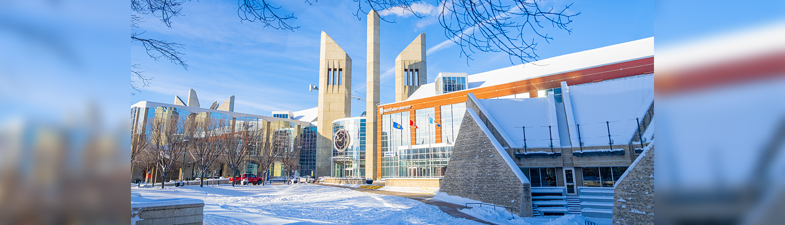 MacEwan's clock tower entrance surrounded by fresh snow.