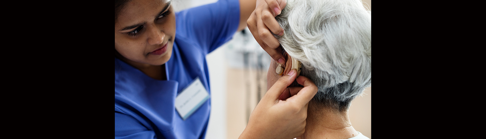 A woman being fitted with a hearing aid