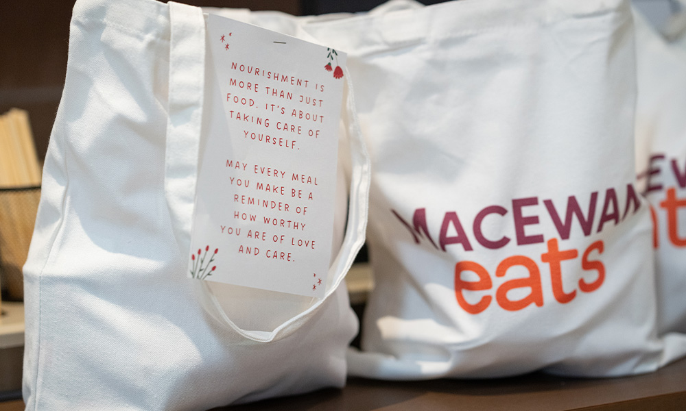 A close-up shot of MacEwan Eats branded reusable cloth bags.