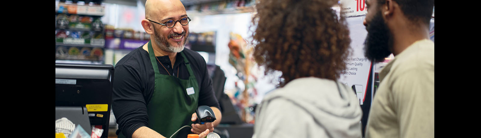 A small business owner serves customers in his store