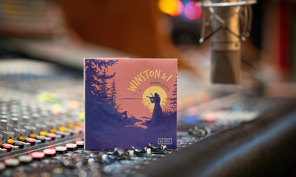 The album cover for "Winston & I" sits on a recording studio mixing board.