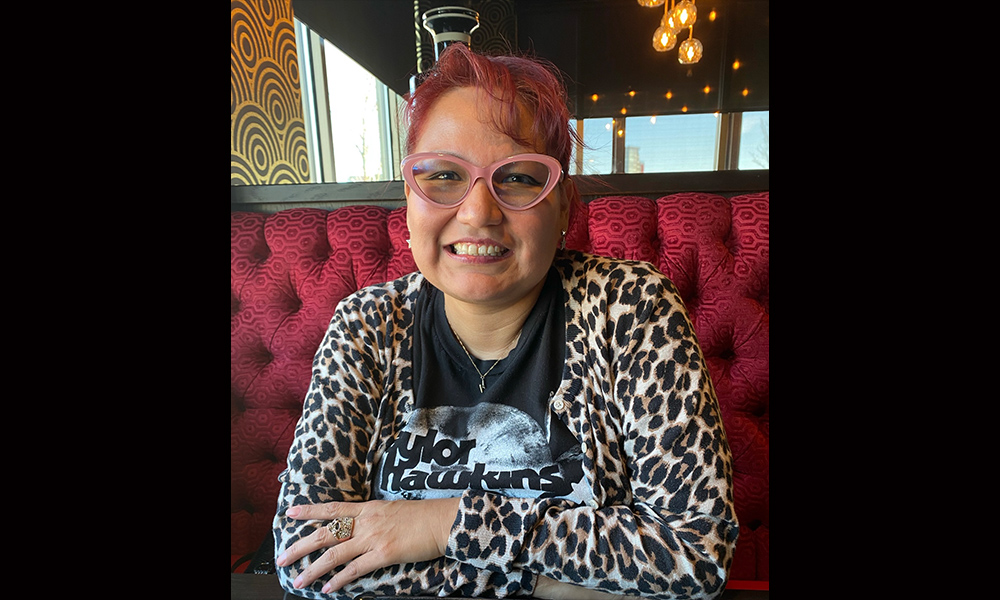 a woman sitting at a table in a diner