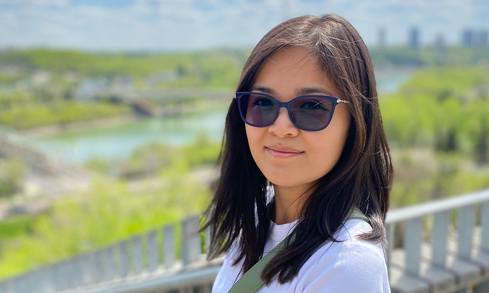 a woman wearing sunglasses smiling at the camera