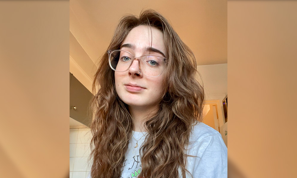 A selife of Rhiannon Besette against a neutral background