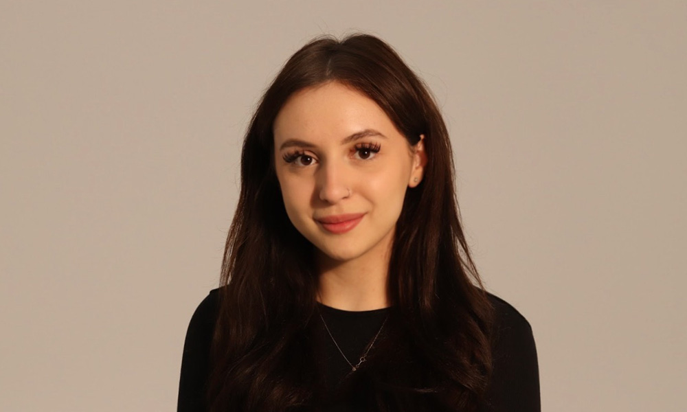A headshot of Elena Mercuri wearing a black sweater