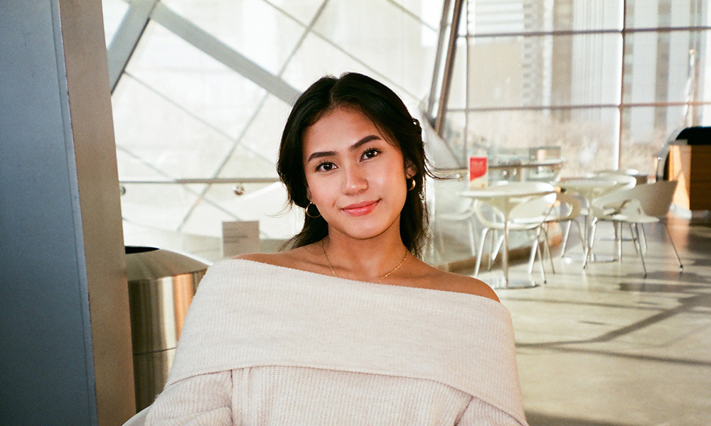a woman sits at a table