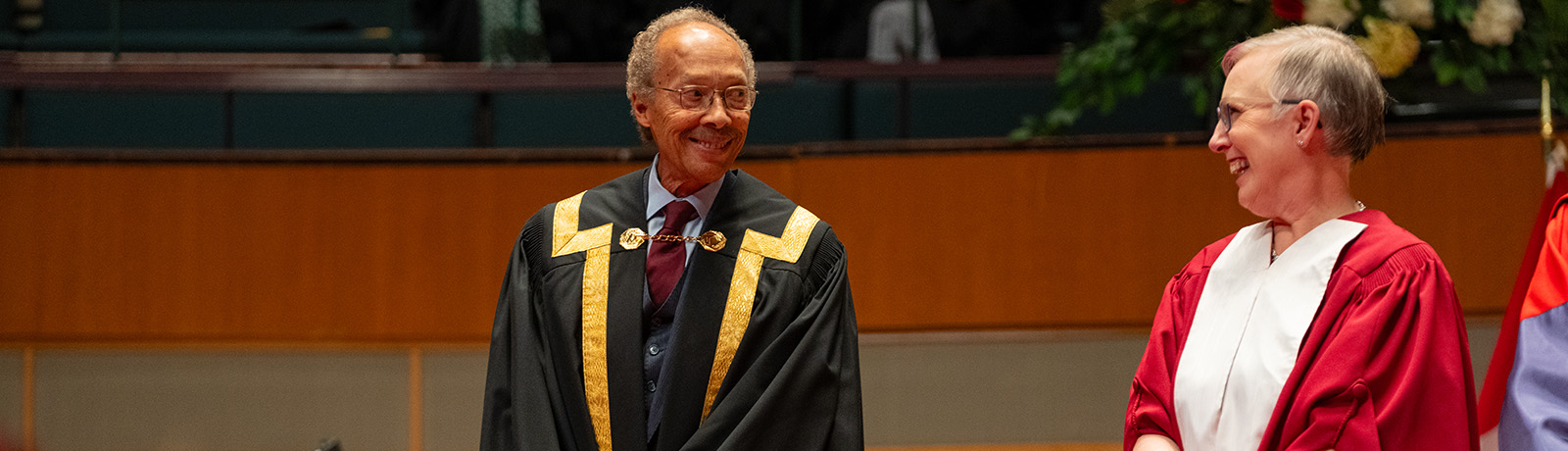 Dr. Tony Fields onstage at convocation with Board Chair Carolyn Graham