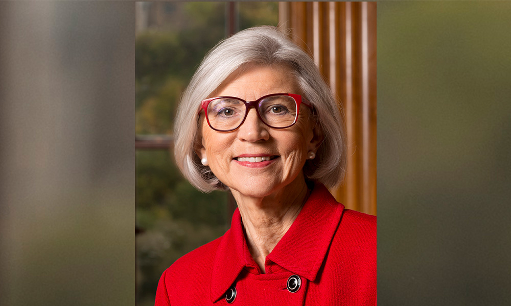 A headshot of Beverley McLachlin smiling and wearing a red jacket