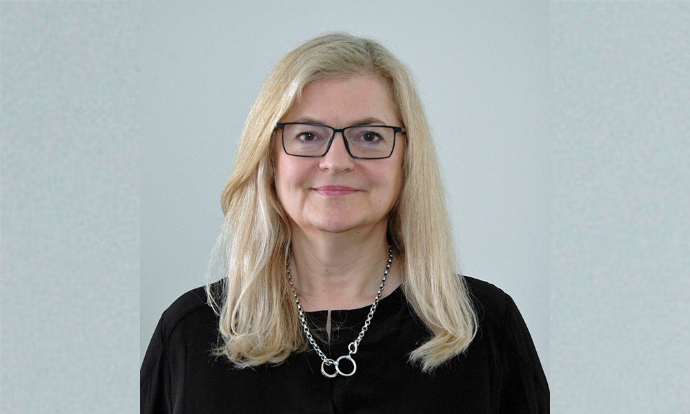A headshot of Linda Wedman wearing a black sweater