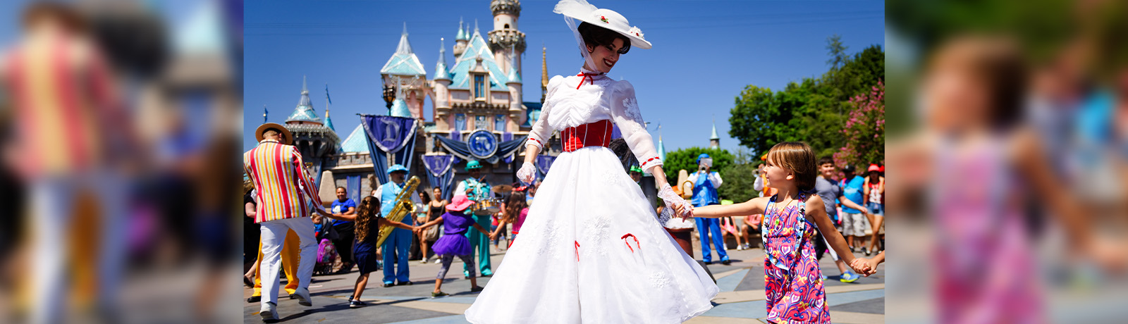 Mary Poppins and a little girl walk through Disneyland.