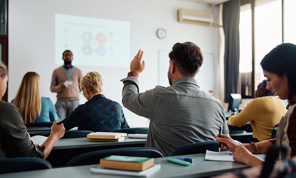 A student raises his hand in class.