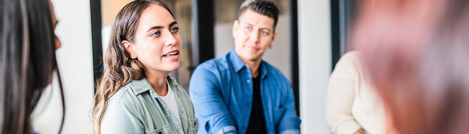 A group of people sit in a circle having a conversation