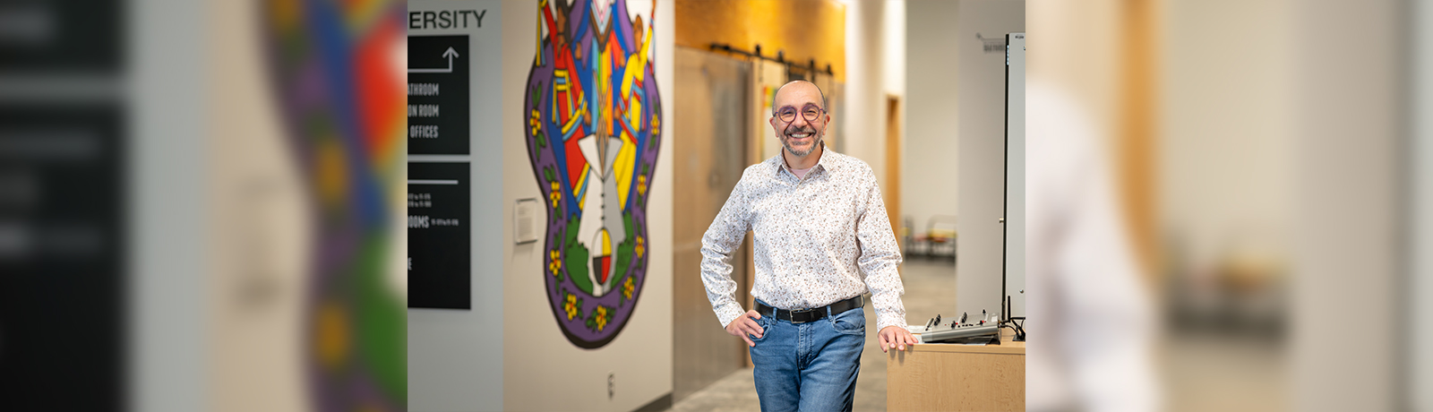 a man leaning on a desk with his hand