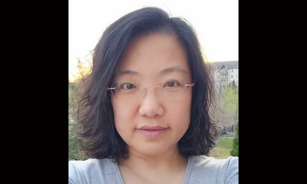 A close-up of the head and shoulders of a woman outside