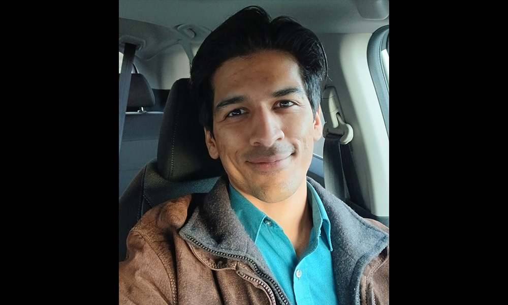 A man sitting in the front seat of a vehicle