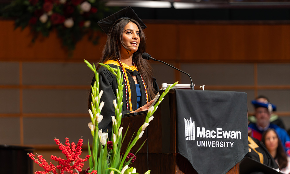 Sahiba Pahwa stands at the podium making her speech