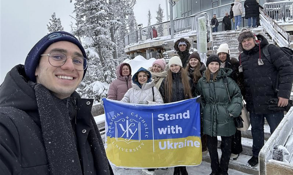 Students stand outside in the snow