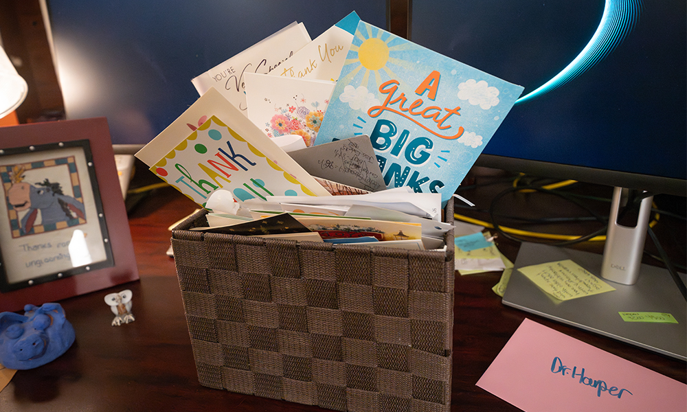 A brown basket full and overflowing with cards