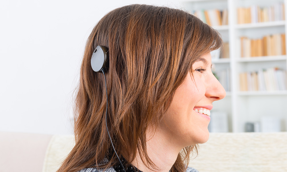 Woman showing cochlear implant