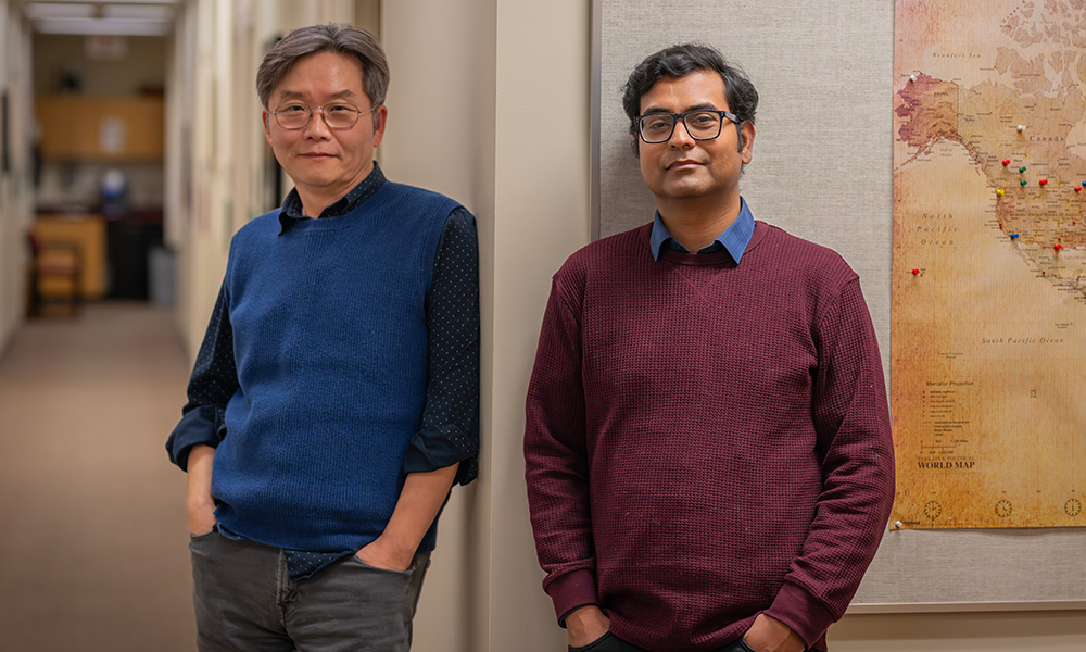 Dr. Joong Son and Dr. Arka Mukherjee outside their offices in Building 5