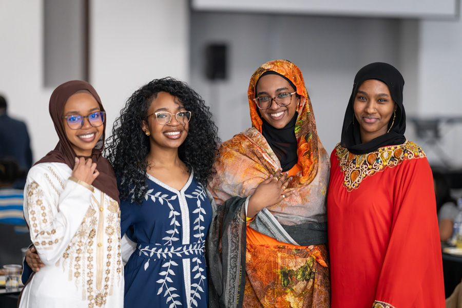 Four students smiling at the Black History Month closing gala