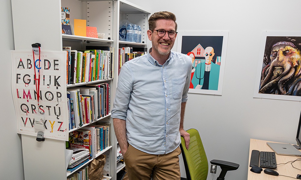 Robert Andruchow smiles while standing in his office