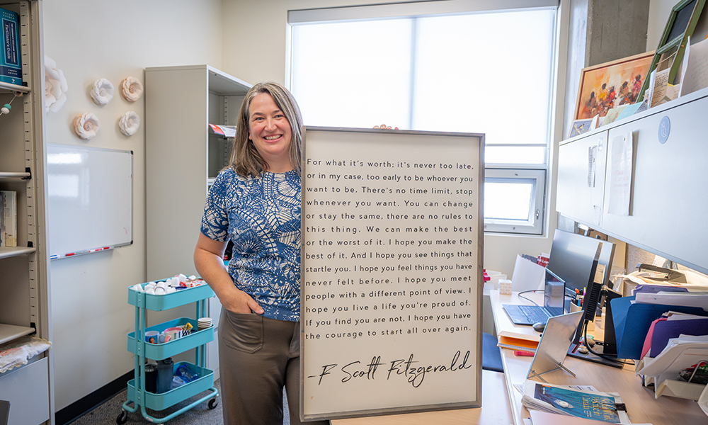 Kealey Dube sits at a table in her office