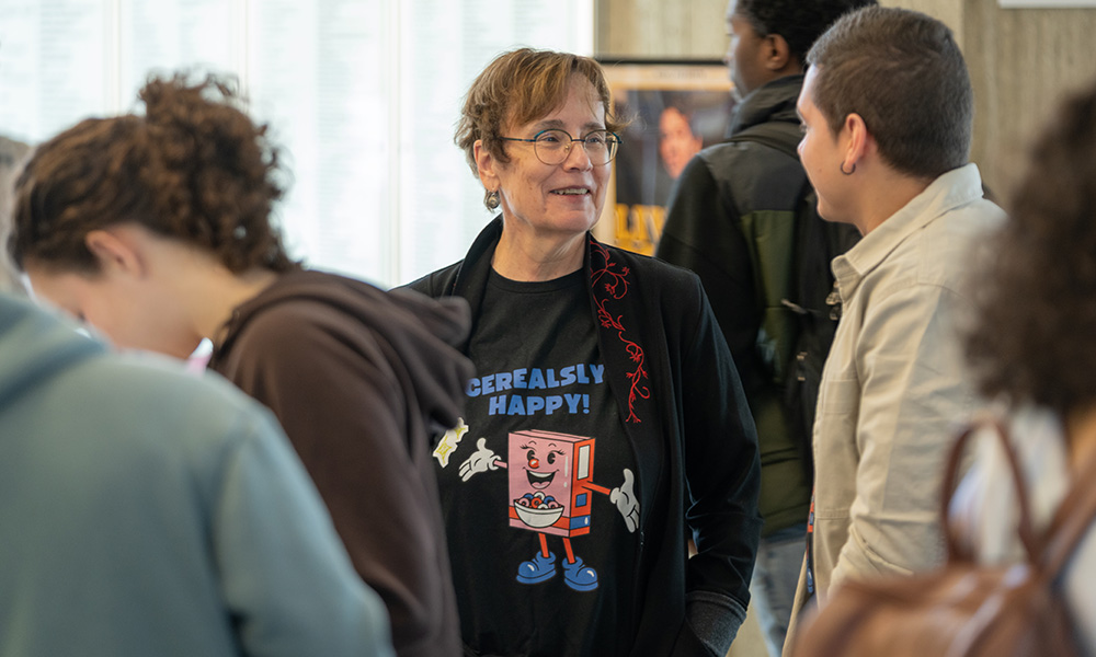 Dr. Trimbee speaks with students at the Cereal-sy Happy event