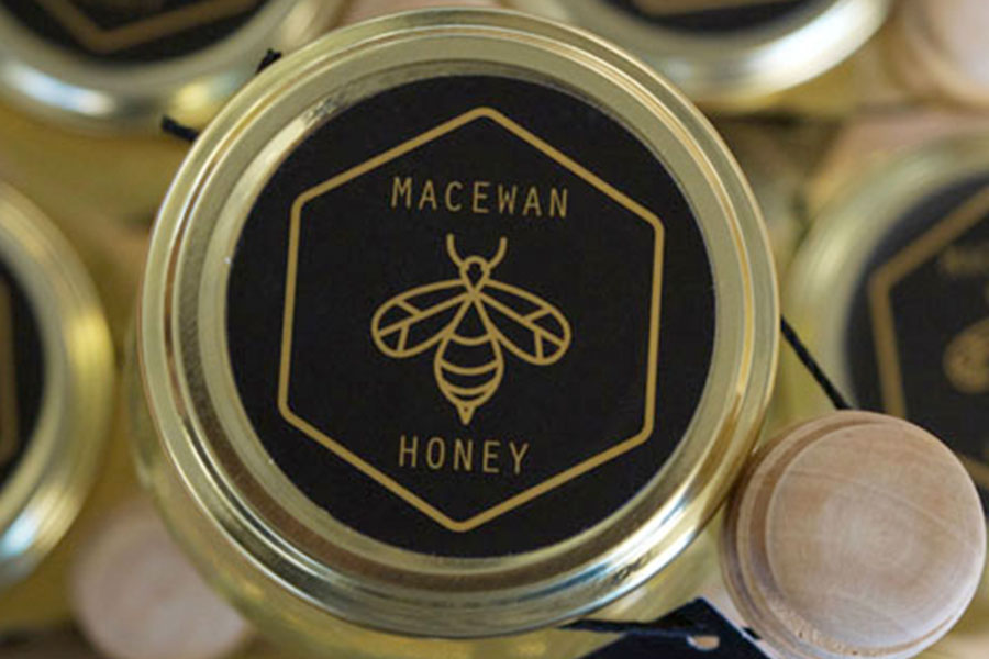 Jars with labels that say "MacEwan Honey"