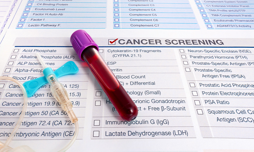 A vial of blood sits atop a sheet of paper with check boxes for different ailments.