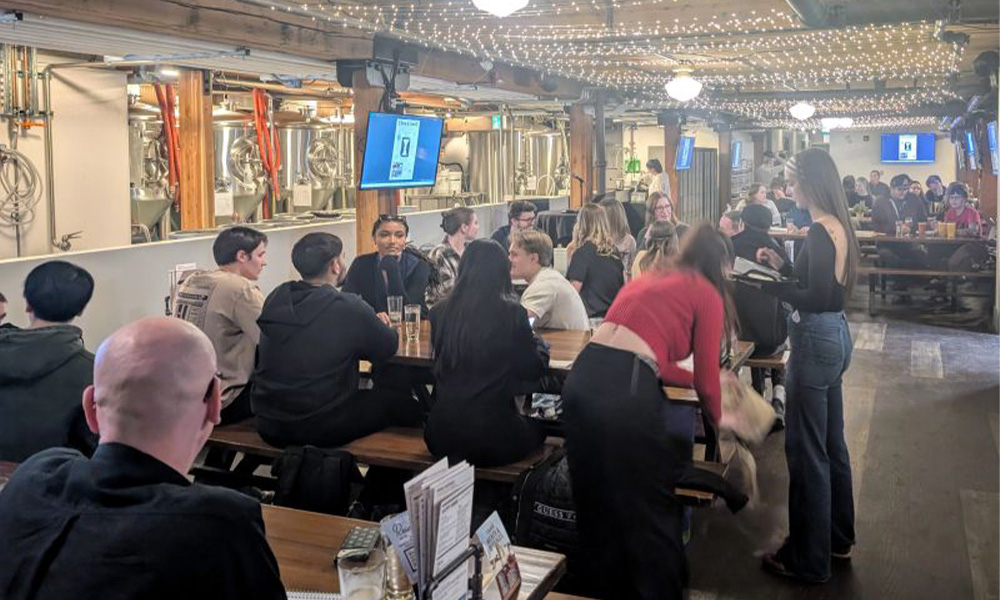 People sit around tables at Campio Brewing.