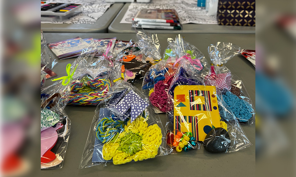 Colourful handmade crafts and keychains are assembled in clear cellophane bags.