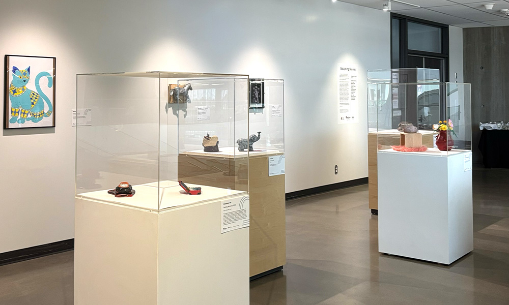 Art sculptures are displayed in glass cases.