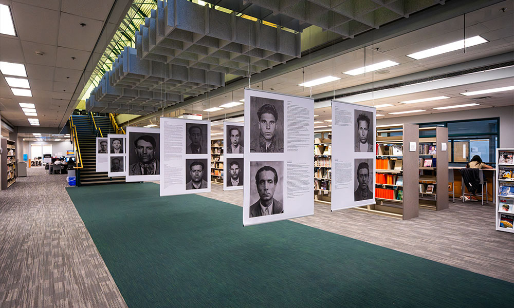 Large hanging banners in the library feature headshots of men, alongside write-ups about each.