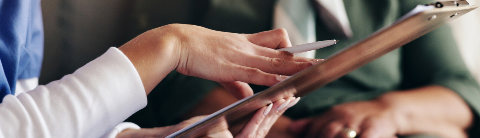 close up of hands with a clipboard