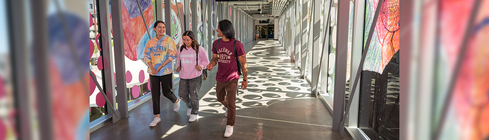 Student walking across a pedway on campus