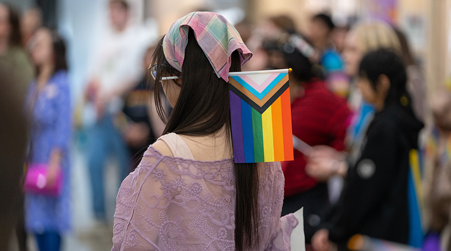 back of a woman's head with a pride flag
