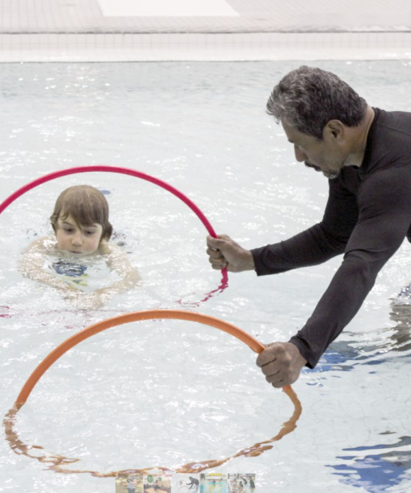 swim instructor with child in pool